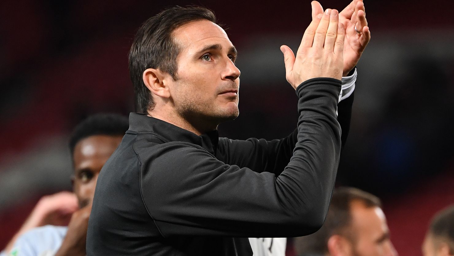 Derby's English manager Frank Lampard applauds the fans following their victory against Manchester United at Old Trafford.
