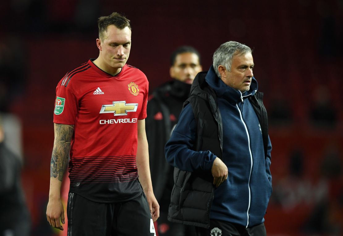 Phil Jones of Manchester United looks dejected after missing his team's eighth penalty.
