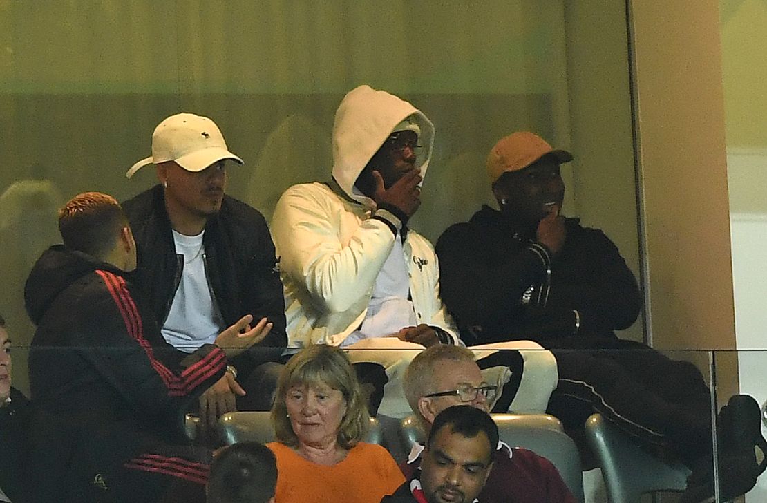 Pogba looks on from the stands during the match against Derby.