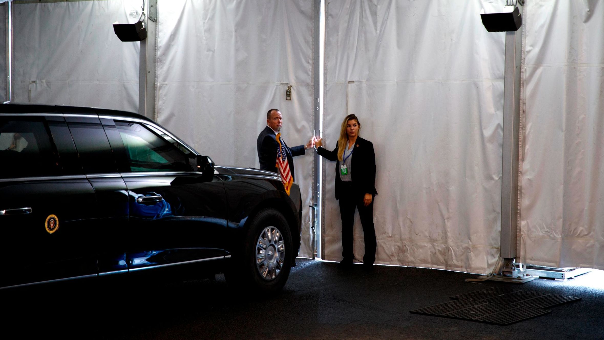 Secret Service agents stand next to President Trump's vehicle on Wednesday.