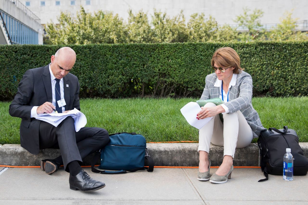 Swiss President Alain Berset makes notes next to delegation member Veronique Haller during a short break on Wednesday.