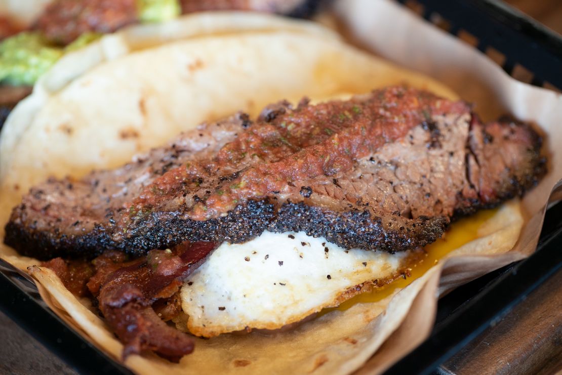 The Real Deal Holyfield breakfast taco includes a fried egg,smoked brisket or pulled pork, potatoes and salsa.