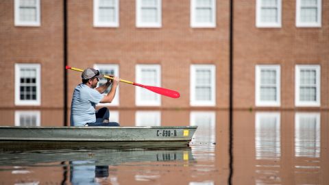 Taylor James on Wednesday paddles a boat in floodwaters caused by Hurricane Florence in front of Trinity United Methodist Church in Conway, South Carolina.