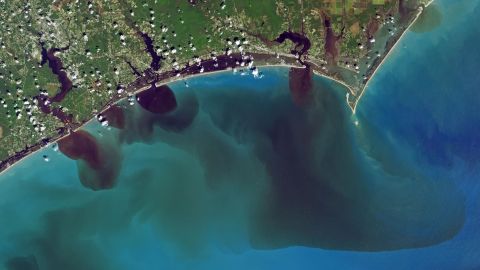 NASA image shows how soils, sediments, pollution and other debris have discolored the White Oak River, New River and Adams Creek, and their outflows along the coast and into the ocean.