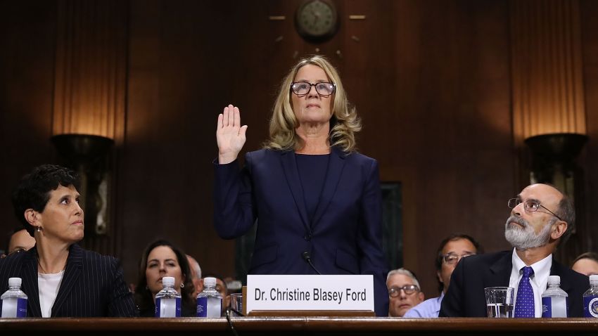 WASHINGTON, DC - SEPTEMBER 27:  Christine Blasey Ford (C) is sworn in before testifying the Senate Judiciary Committee with her attorneys Debra Katz (L) and Michael Bromwich (R) in the Dirksen Senate Office Building on Capitol Hill September 27, 2018 in Washington, DC. A professor at Palo Alto University and a research psychologist at the Stanford University School of Medicine, Ford has accused Supreme Court nominee Judge Brett Kavanaugh of sexually assaulting her during a party in 1982 when they were high school students in suburban Maryland. In prepared remarks, Ford said, ÒI donÕt have all the answers, and I donÕt remember as much as I would like to. But the details about that night that bring me here today are ones I will never forget. They have been seared into my memory and have haunted me episodically as an adult.Ó  (Photo by Win McNamee/Getty Images)