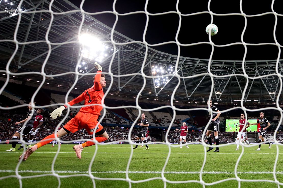 Kieran O'Hara of Macclesfield Town fails to save a shot from West Ham's Ryan Fredericks.