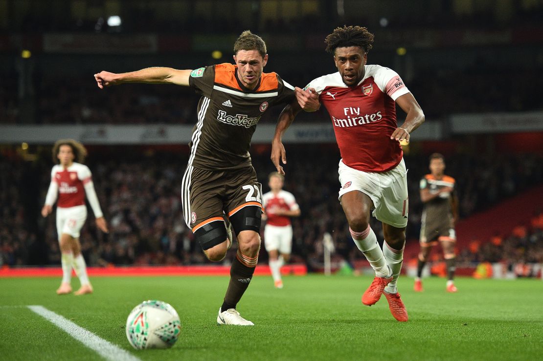 Brentford's Danish defender Henrik Dalsgaard vies with Arsenal's Nigerian striker Alex Iwobi.