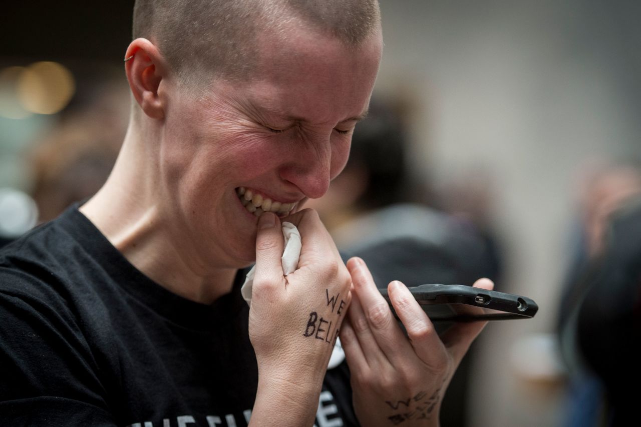 Joy Gerhard cries in the Hart Senate Office Building atrium as she listens to Ford's testimony on her phone.