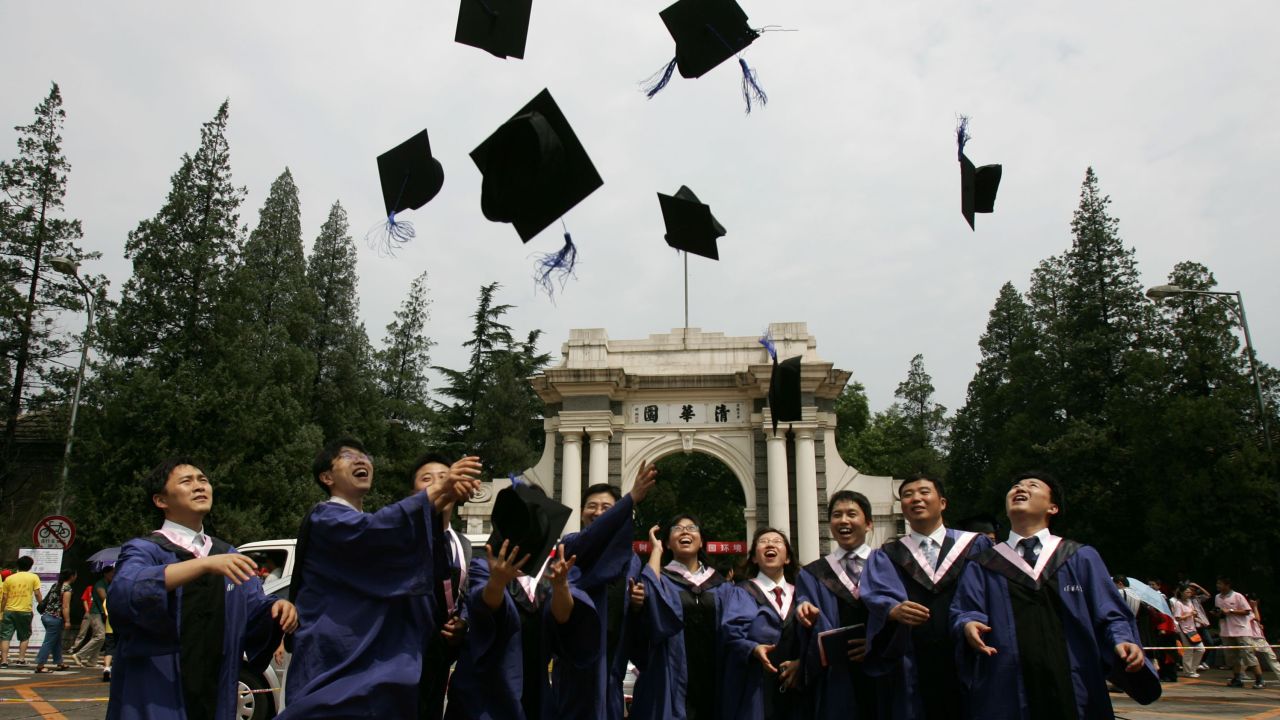 Students throw their mortar boards into the air as they graduate during a ceremony held at the Tsinghua University on July 18, 2007 in Beijing, China. 