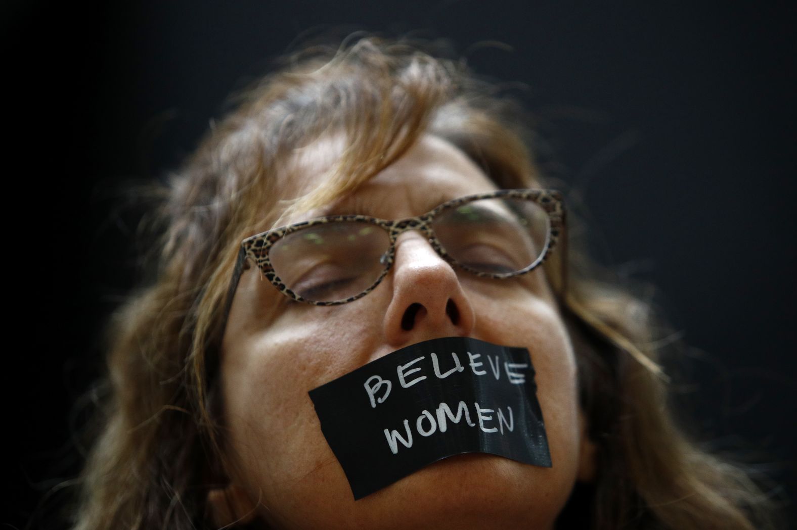A protester wears a piece of tape over her mouth inside the Hart Senate Office Building.