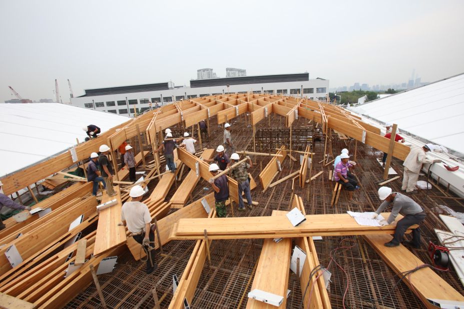 Construction workers assemble a roof with prefabricated parts for a pavilion hosting an artificial intelligence conference in Shanghai. 