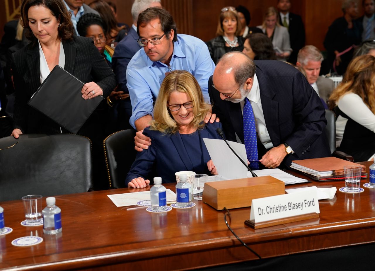 Ford is joined by her lawyer Michael Bromwich, right, and family friend Keith Koegler during one of the breaks in testimony.