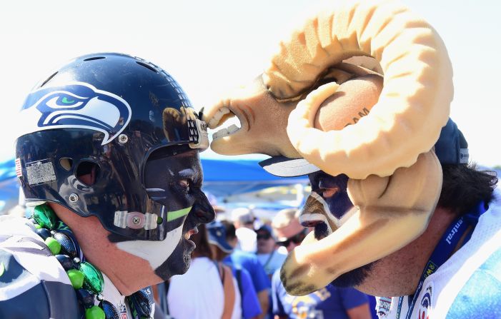 Seattle Seahawks fan Brad Carter, aka "Cannonball" (L) faces off with Karl Sides, aka "The Ram Man" (R) before the start of the Los Angeles Rams home opening NFL game at the Los Angeles Memorial Coliseum on September 18, 2016.