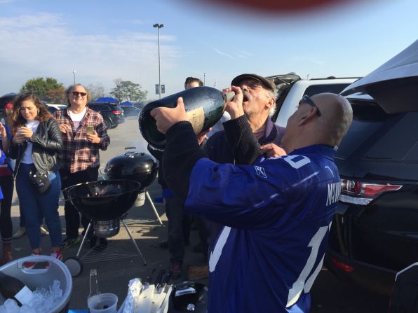 Hank Uberoi (right) spares no expense when it comes to tailgating before Giants games, even when the team is losing. "Tailgates are an independent event," he says. 