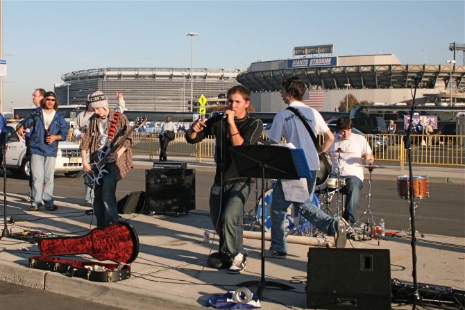 Uberoi's son brought his band to a tailgate, while the team was still preparing MetLife Stadium (left, background). 