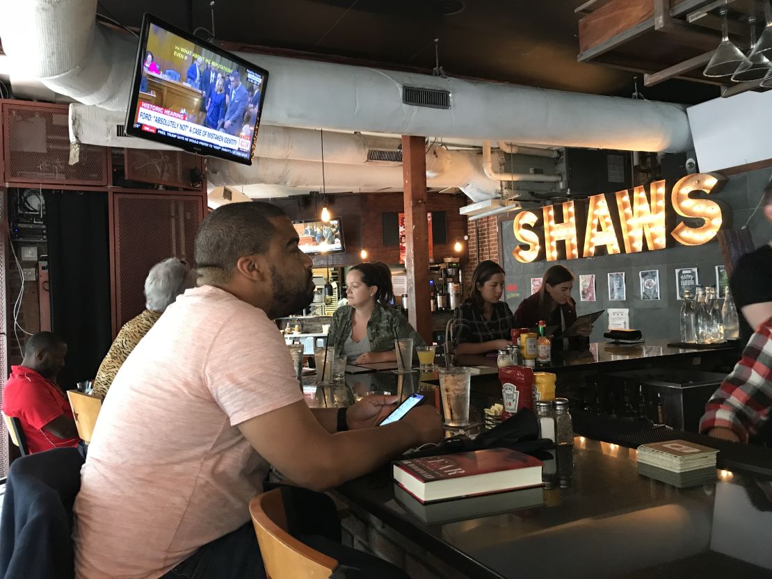 Jamar Guy, 35, a banker, watches at Shaw's Tavern in Washington.