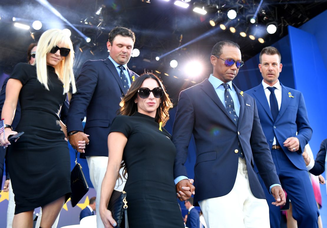 Tiger Woods leaves the opening ceremony with partner Erica Herman.