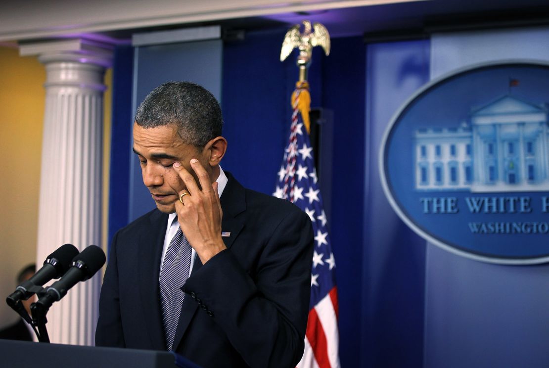 President Barack Obama wipes tears as he makes a statement in response to the elementary school shooting in Connecticut on  December 14, 2012.