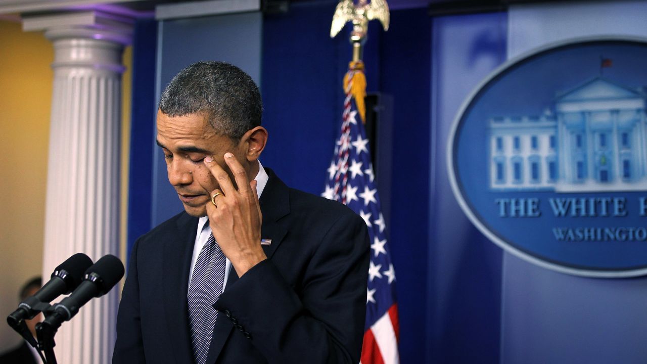President Barack Obama wipes tears as he makes a statement in response to the elementary school shooting in Connecticut on  December 14, 2012.