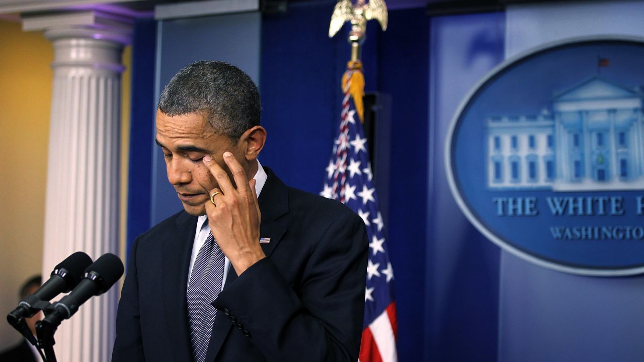 President Barack Obama wipes tears as he makes a statement in response to the elementary school shooting in Connecticut on December 14, 2012.