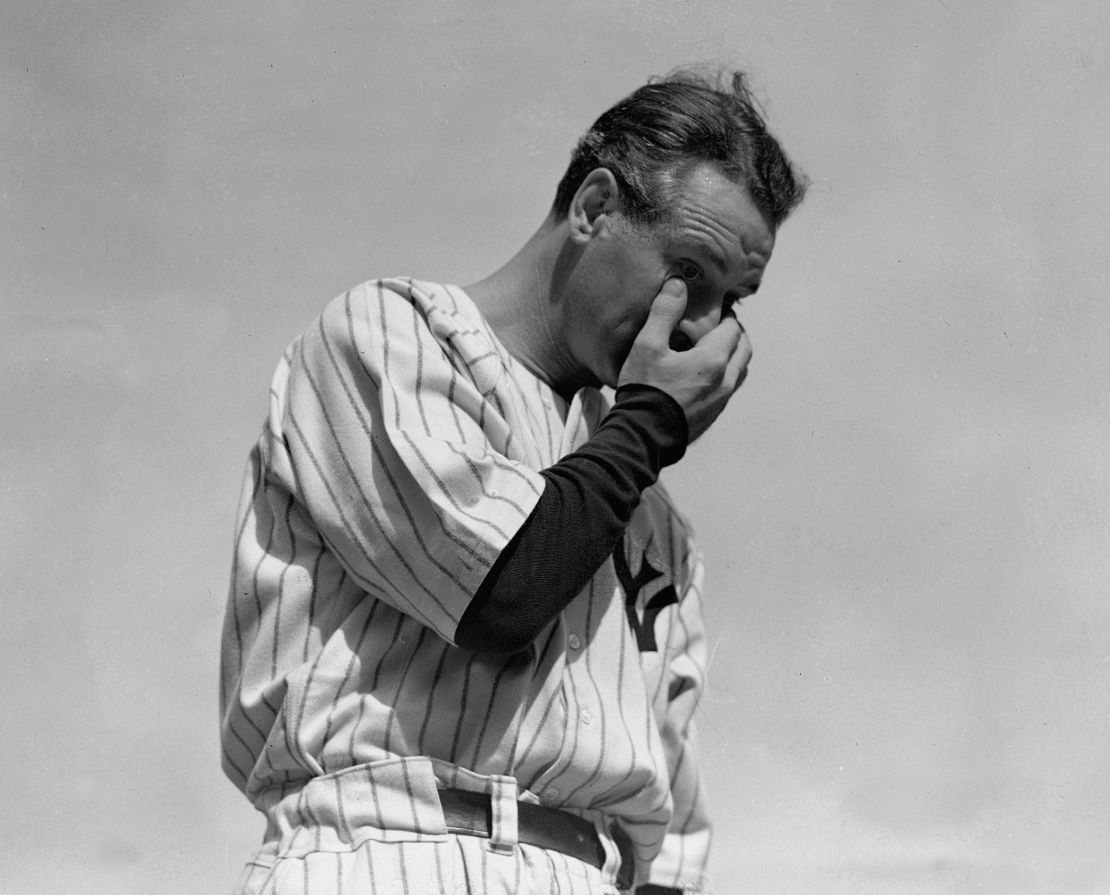 New York Yankees' Lou Gehrig wipes away a tear while speaking during a sold-out tribute at Yankee Stadium on July 4, 1939. Gehrig's record breaking career was cut short by neuromuscular disease. 