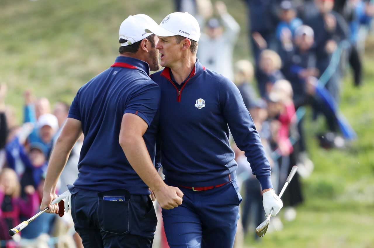 Europeans Jon Rahm (left) and Justin Rose celebrate during the Friday morning four-ball matches. The pair lost their lead to Tony Finau and Brooks Koepka. 