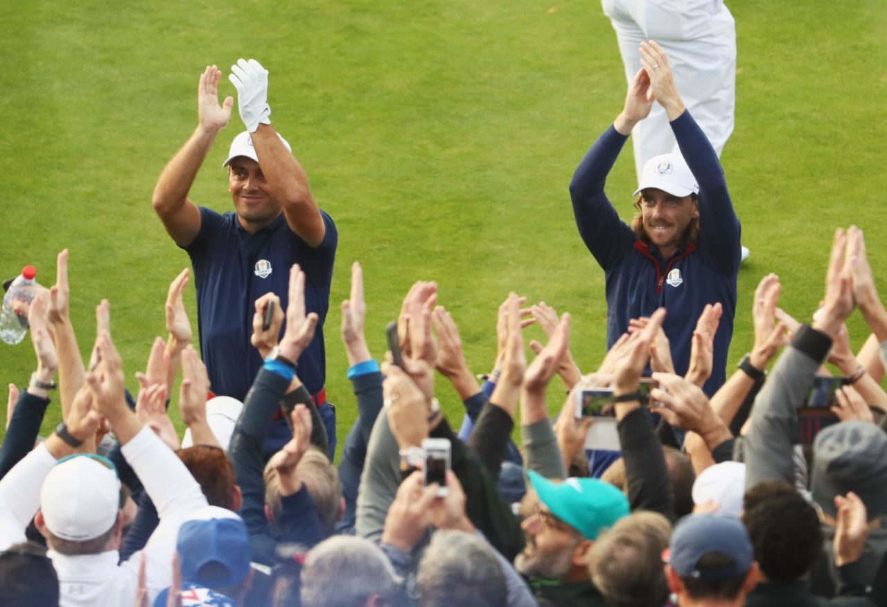 Molinari (left) and Fleetwood went up against the American pair of Woods and Patrick Reed and secured a crucial point Friday for the Europeans.