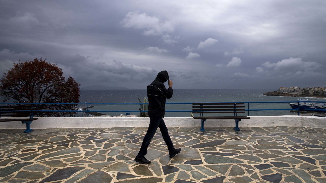 A man walks alongside the Rafina Port during heavy storm in Athens, Greece on September 28.