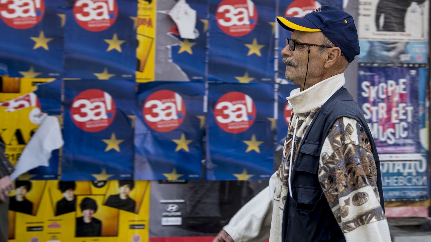 A man walks past posters in Skopje reading "Yes for European Macedonia" before the heated referendum vote.