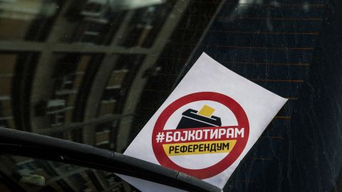 A flyer reading "I boycott" is seen on the windscreen of a car in Skopje.