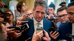Sen. Jeff Flake, R-Ariz., center, speaks with reporters after meeting with Senate Majority Leader Mitch McConnell of Ky., in his office in the Capitol in Washington, Friday, Sept. 28, 2018. The Senate Judiciary Committee advanced Brett Kavanaugh's nomination for the Supreme Court after agreeing to a late call from Sen. Jeff Flake, R-Ariz., for a one week investigation into sexual assault allegations against the high court nominee. (AP Photo/Andrew Harnik)