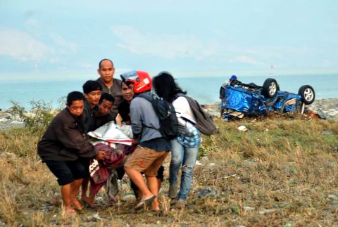 People carry a victim in Palu on September 29.