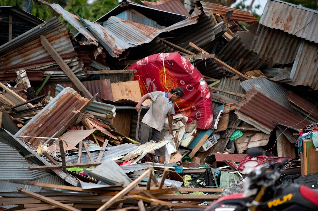 A man searches for his belongings in the ruins of his house in Palu on Saturday, September 29.