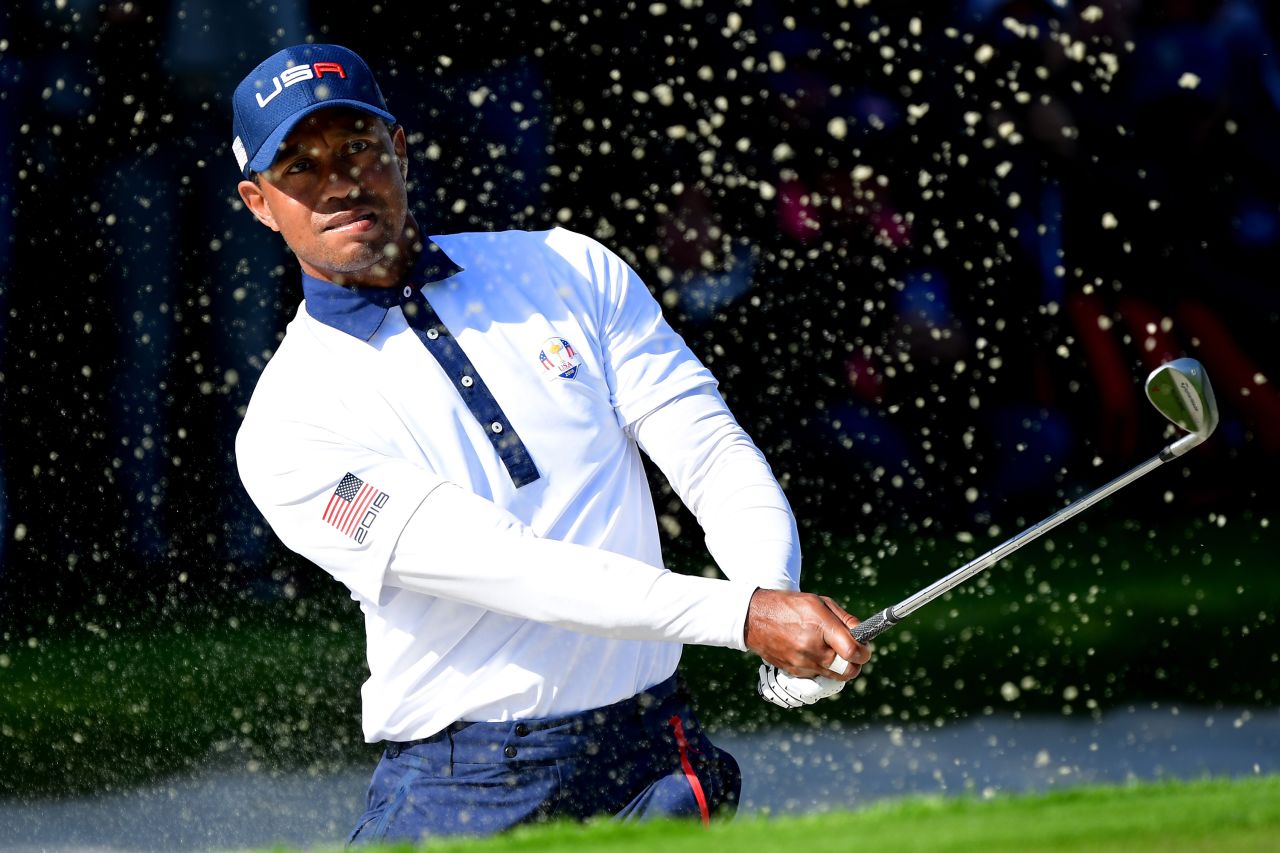 Tiger Woods of the United States plays out of a bunker during the Saturday afternoon foursomes matches.  