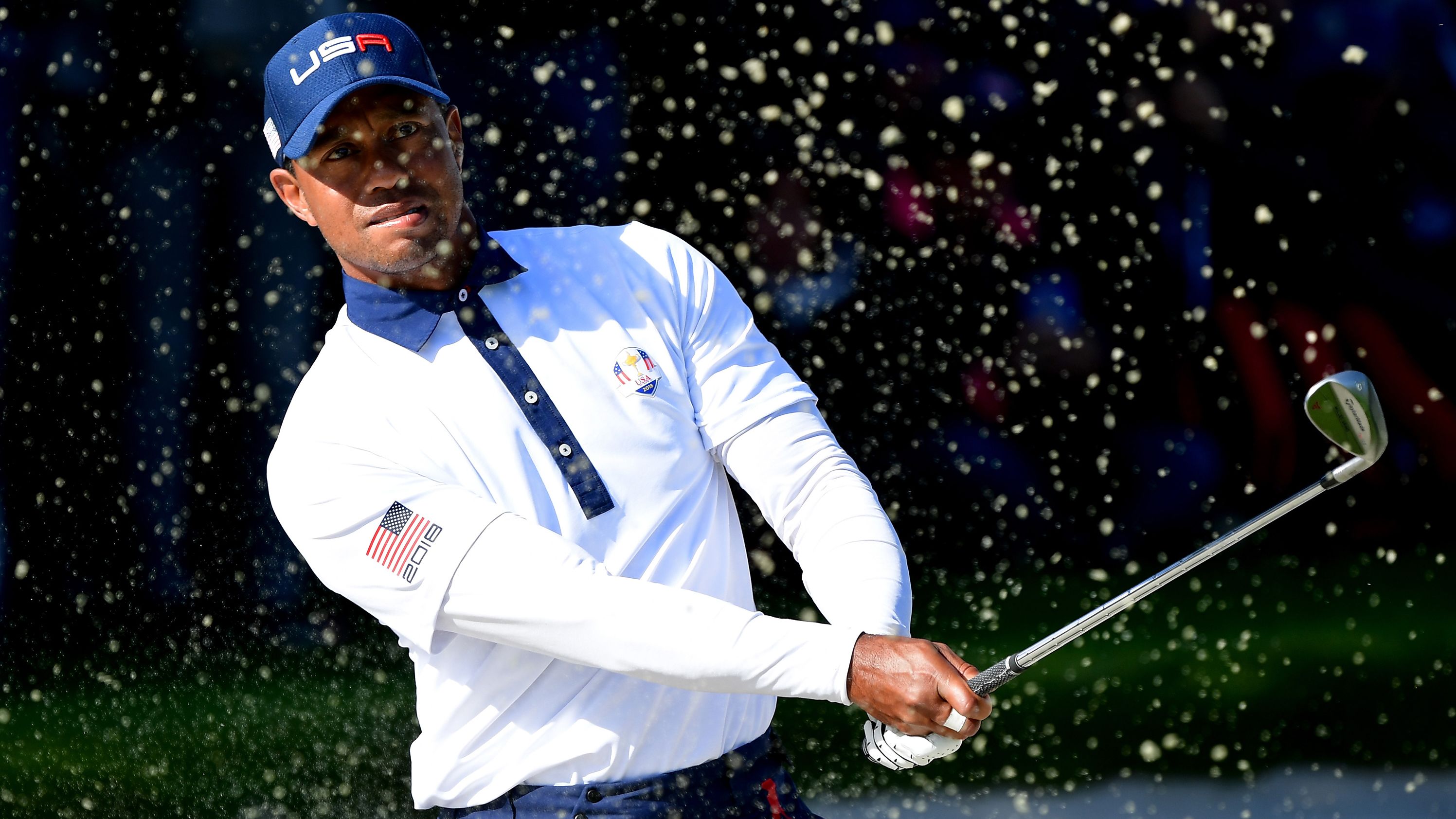 Tiger Woods of the United States plays out of a bunker during the Saturday afternoon foursomes matches.  