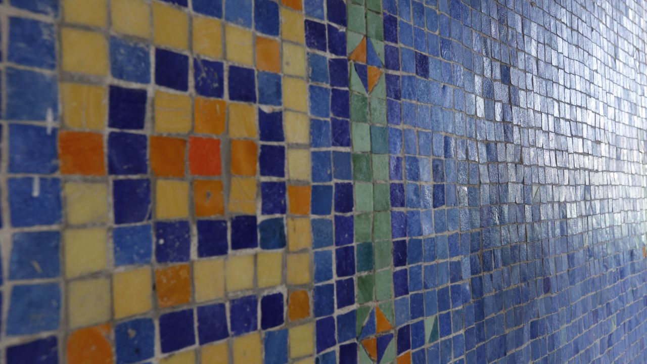 Murano glass tiles from Italy were hand-cut and hand-set for the walls and floors surrounding the indoor pool.