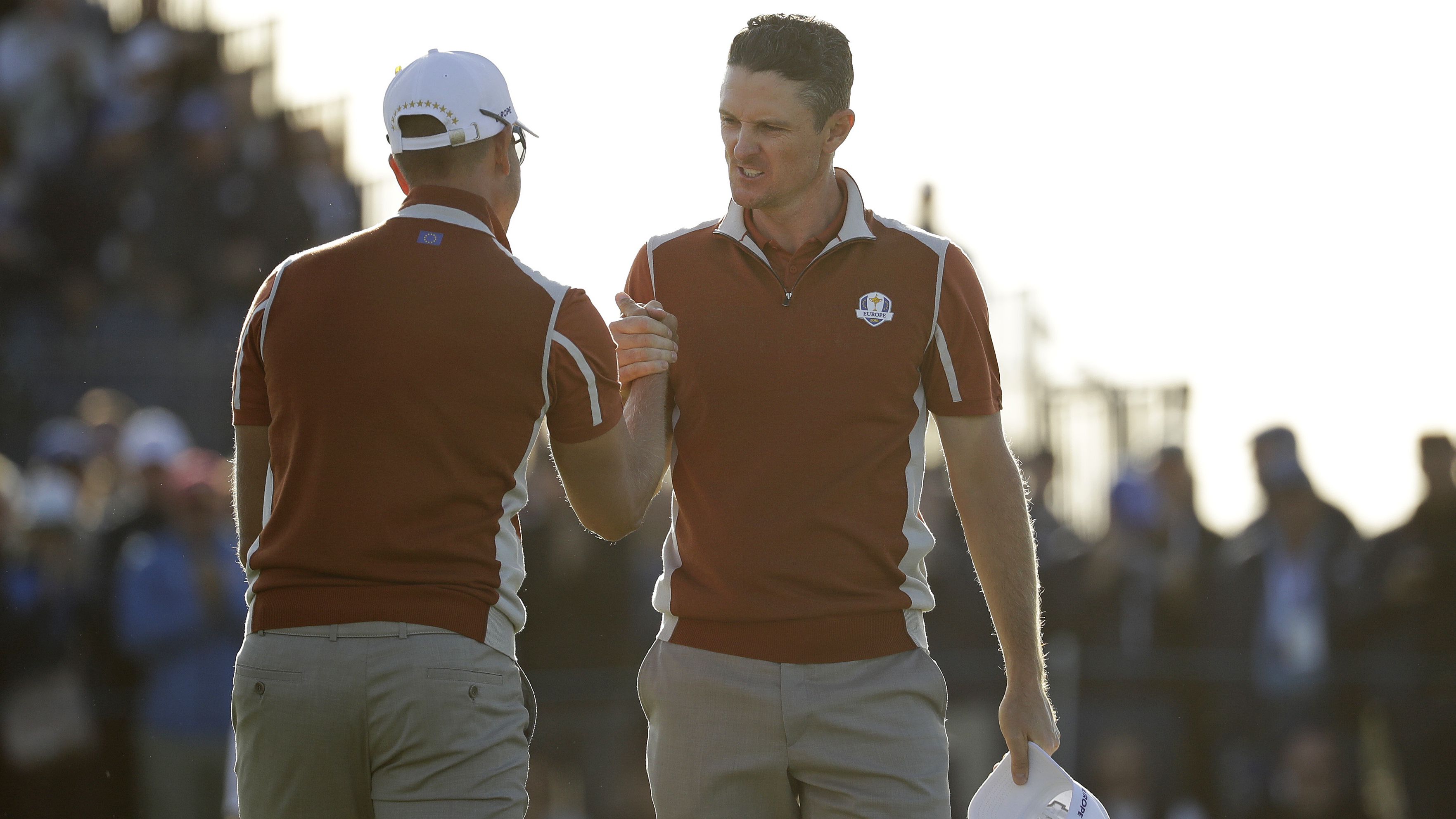Europe's Justin Rose, right, celebrates with teammate Henrik Stenson on the 17th green after winning a foursomes match Saturday.