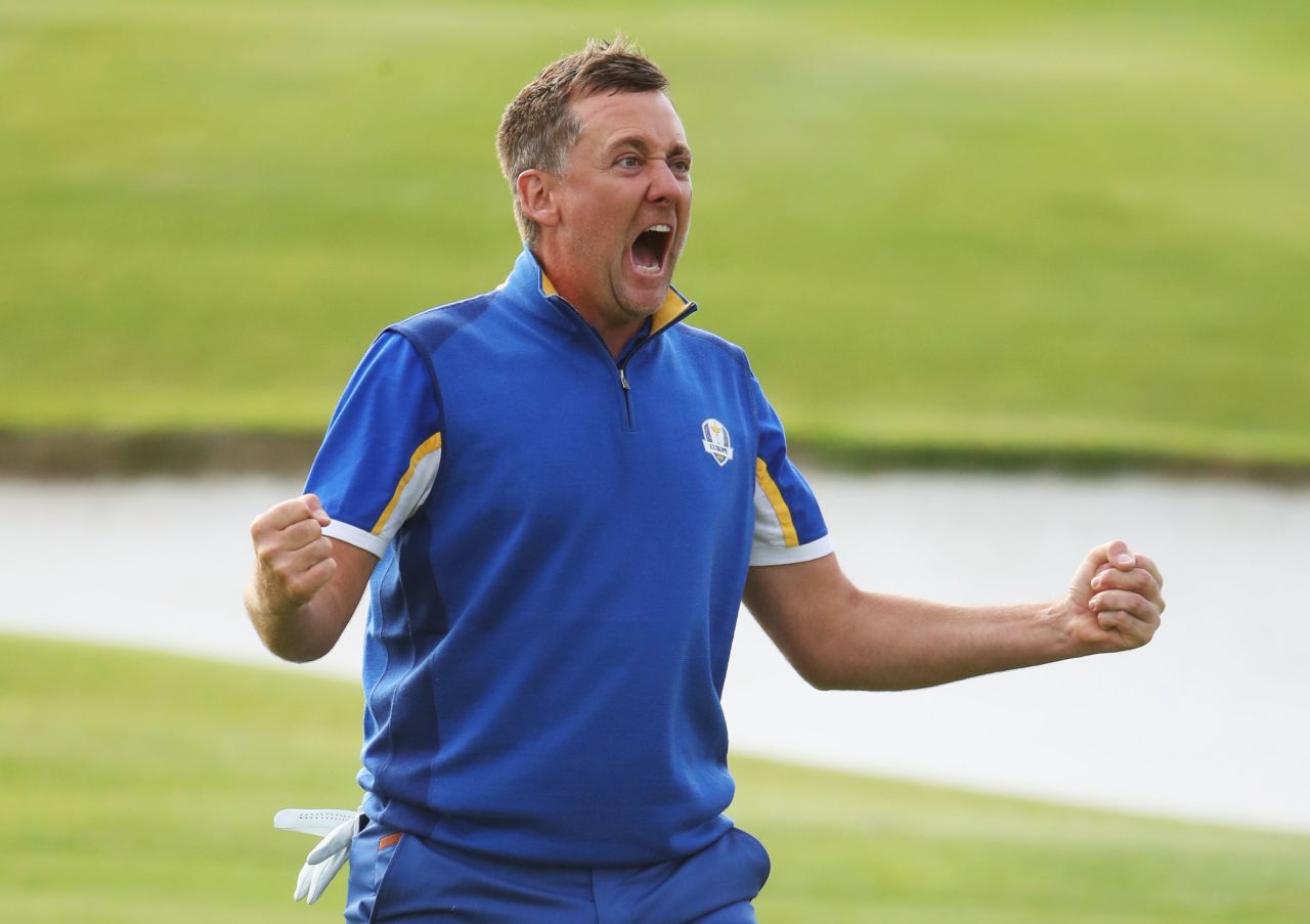 Ian Poulter of Europe celebrates winning his match on the 18th hole during singles matches on Sunday.