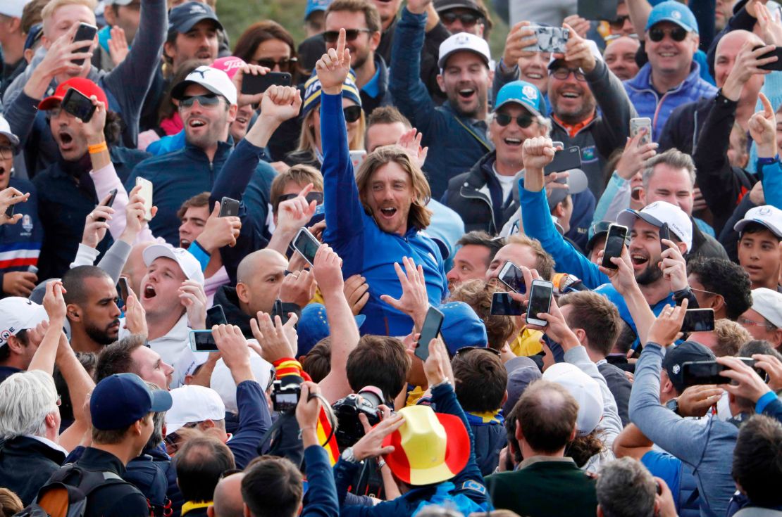 Team Europe's Tommy Fleetwood celebrates with spectators after winning the Ryder Cup in France.