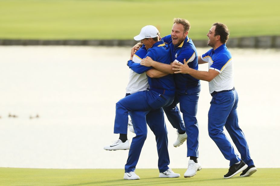 Alex Noren of Europe celebrates with his teammates after winning his match on the 18th green. Europe won the Ryder Cup, defeating the US team on Sunday, September 30 in Paris, France. 