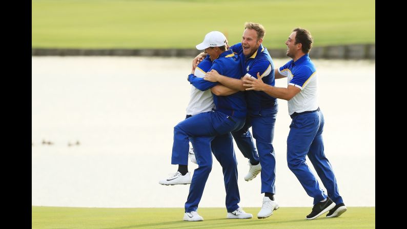 Golfer Alex Noren of Europe celebrates with his teammates after winning the match on the 18th green. Europe won the Ryder Cup, defeating the US team on Sunday, September 30, in Paris.
