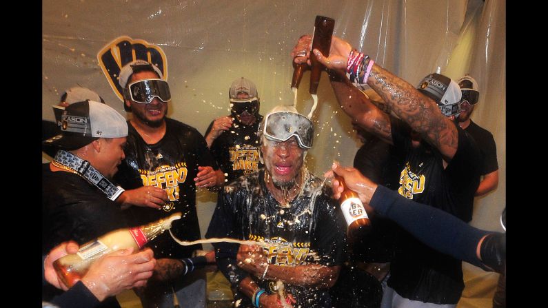Keon Broxton of the Milwaukee Brewers is doused by his teammates as they celebrate beating the St. Louis Cardinals and clinching a Major League Baseball playoff berth on Wednesday, September 26, in St. Louis.