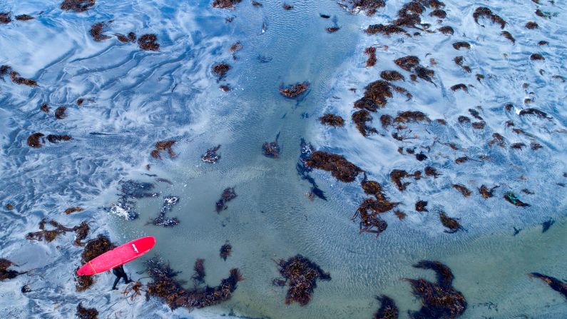 A surfer walks out of the water after a free surf session on Wednesday, September 26, in Flackstad, Northern Norway, on the eve of the Lofoten Masters. Held in Unstad, Norway, the Lofoten Masters is the northernmost surf contest.