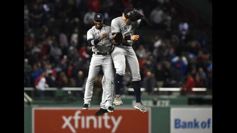 New York Yankees baseball player Andrew McCutchen celebrates with teammate Aaron Judge after defeating the Boston Red Sox on Friday, September 28, in Boston.