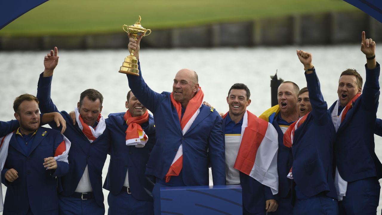 (L-R) Europe's English golfer Tyrrell Hatton, English golfer Paul Casey, Spanish golfer Sergio Garcia,  Danish captain Thomas Bjorn, Northern Irish golfer Rory McIlroy, Swedish golfer Alexander Noren, Danish golfer Thorbjorn Olesen and English golfer Ian Poulter celebrate with the trophy after winning the 42nd Ryder Cup at Le Golf National Course at Saint-Quentin-en-Yvelines, south-west of Paris, on September 30, 2018. (Photo by Eric FEFERBERG / AFP)        (Photo credit should read ERIC FEFERBERG/AFP/Getty Images)