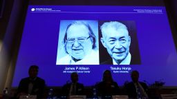 Members of the Nobel Committee for Physiology or Medicine sit in front of a screen displaying James P Allison (L) and Tasuku Honju, the winners of the 2018 Nobel Prize in Physiology or Medicine, during a press conference at the Karolinska Institute in Stockholm, Sweden, on October 1, 2018. - James P Allison of US and Tasuku Honjo of Japan won Nobel Medicine Prize for their achievements in cancer treatment. (Photo by Jonathan NACKSTRAND / AFP)        (Photo credit should read JONATHAN NACKSTRAND/AFP/Getty Images)