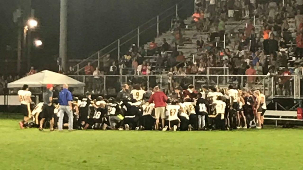 Players and coaches from both teams knelt in prayer after Dylan Thomas was taken to the hospital.