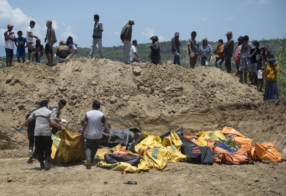Body bags lie in an open ditch in Palu, Indonesia.