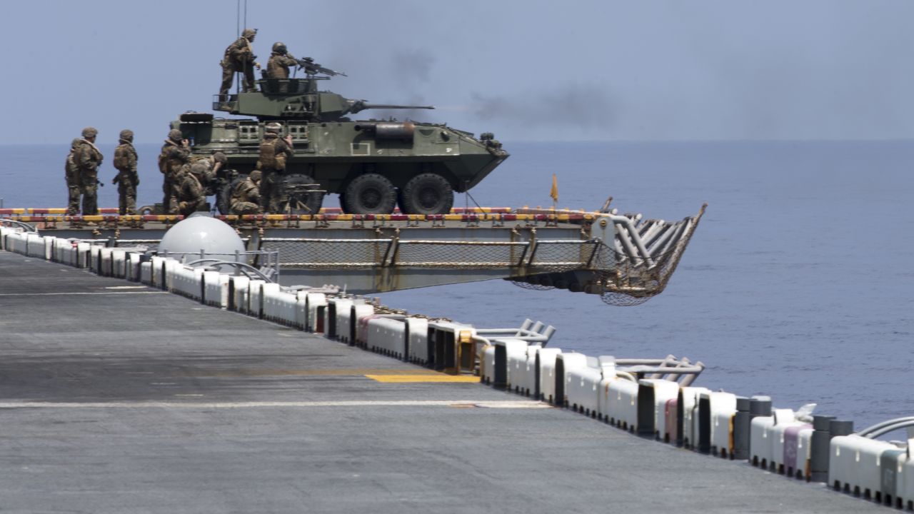 US Marines aboard a Light Armored Vehicle on the flight deck aboard the amphibious assault ship USS Wasp fire weapons while underway in the South China Sea on Sept. 27, 2018.