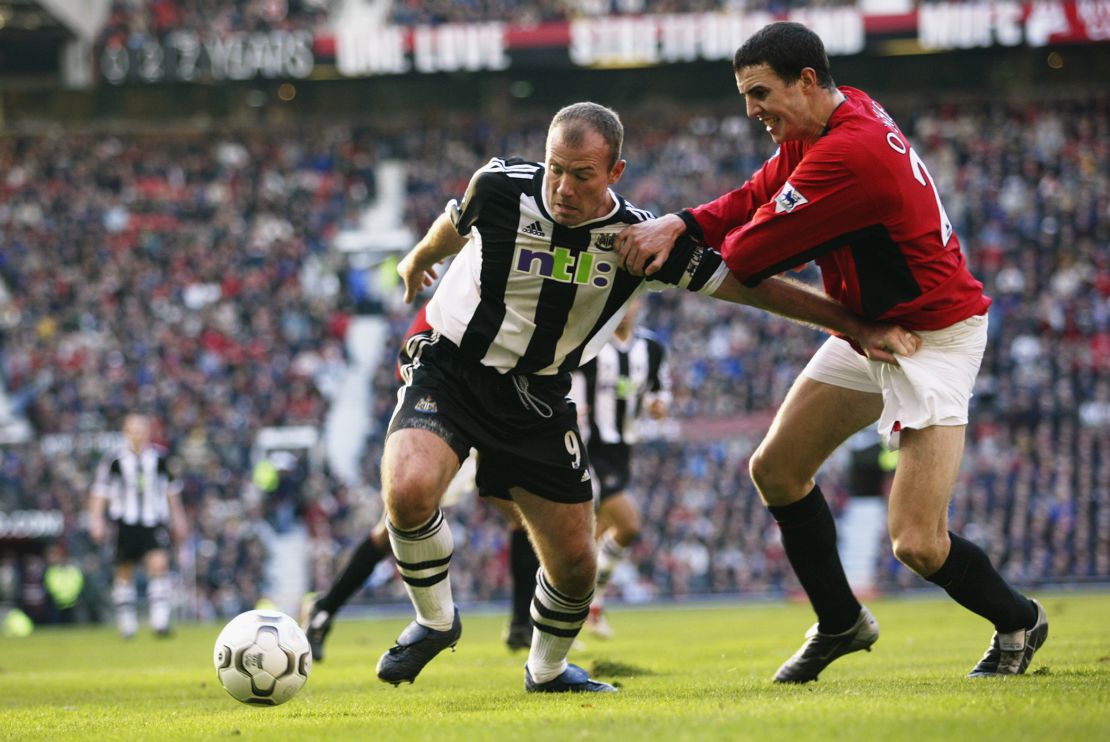 Shearer (left) wrestles with Manchester United defender John O'Shea in 2002, a game the Red Devils won 5-3. 